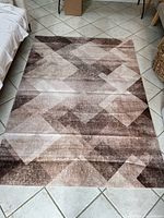 Full view of KOSHANI Sahara area rug showing geometric brown/taupe pattern