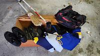 Overall lot showing backpack, pump, broom, shoes, jersey in box