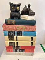 Full stack of eight books with owl figurine, sphinx box, scarab box on top