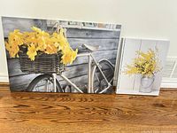 Both canvas prints leaning against wall showing size difference and designs