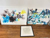 Group shot of both canvases and framed print on floor