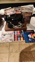 Front view of sewing machine on case with books arrayed
