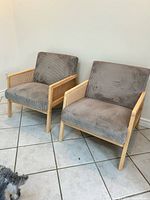 Both chairs side by side showing overall style, upholstery, wood frame and cane panels