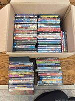 Open box showing majority of DVD and Blu-ray cases stacked