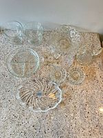 Overall view of all clear glass pieces on countertop