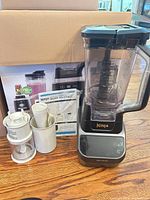 Entire lot showing blender base, pitcher, lid, chopper cups, plunger and manual