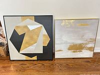 Both framed abstract wall art pieces side by side