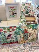 Group shot of canvases, framed print, folded curtain panels and boxed curtain rod