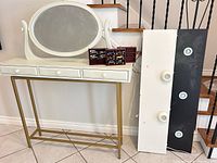 Console table with mirror, display boxes and toy cars placed on top