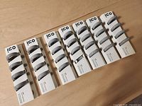 Fourteen INO packages each holding two grey ceramic napkin rings