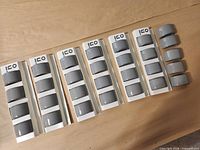 All 29 grey napkin rings in original Ico sleeves, laid out