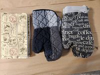 two oven mitts and folded zip pouch