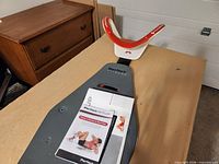 Full view of Perfect Situp trainer with manual on board