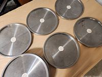 Six of the metal turntables showing top surfaces