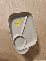 Stack of two plastic compartment plates showing top layout with divider and round section