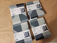 Four packaged SVARTHÖ pillow covers
