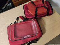 Two red insulated cases with one glass dish visible