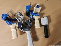 Group shot of all six tape dispensers showing variety and condition