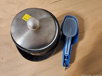 Bucket with lid next to nested scoops