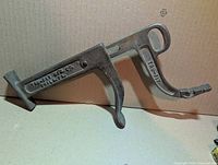 Full view of cast metal shoe stretcher showing maker’s marks