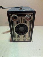 Front view showing Art Deco faceplate, lens, viewfinders and model marking