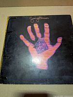 Front of gatefold jacket showing artwork, wear and taped spine