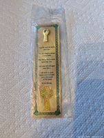 Bookmark and lapel pin sealed in plastic