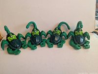 Four identical green Scorpion Stingstriker toys