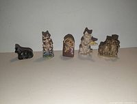 Front view of five Wade nursery rhyme mini figurines in a row