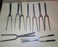 Group shot of all nine steel curling irons laid out