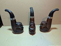 Three brown glass Avon pipe bottles front view