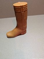 Tan plastic Avon Dingo cowboy boot decanter standing upright