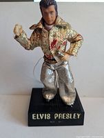 Front view of Elvis Presley figural radio on black base