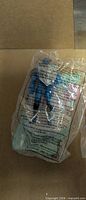 Sealed action figure visible through clear bag