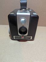 Front view of Kodak Brownie Hawkeye Flash camera showing lens, viewfinder window, nameplate