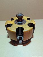 Side view of solid wood poker chip carousel showing six chip slots and top knob