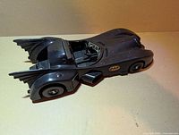 Left side view of Batmobile showing body, wheels, fins