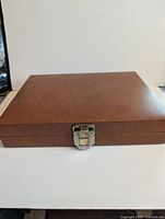 Closed brown faux leather case with latch