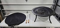 Full set showing fire pit assembled with screen, tools and cover
