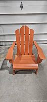 Front view of orange Adirondack chair unfolded