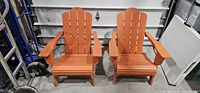 Pair of orange Adirondack chairs front view