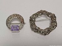 Front view of both brooches showing designs and stones