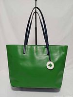 Front view of green Kate Spade Tanya tote with charm visible