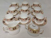 Full set showing 9 cup and saucer pairs, creamer, sugar bowl