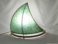 Lamp lit, showing illuminated green fiberglass sail shade and brass frame