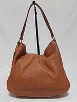 Front view showing embossed crest and overall condition