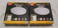 Front view of both sealed Halo Home downlight boxes