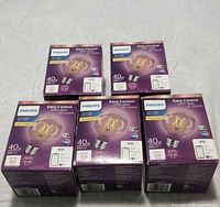 Five sealed Philips WiZ smart Wi-Fi LED bulb boxes front view