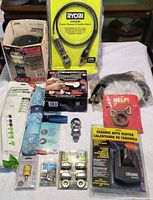 Overall view of all packaged items including lantern, hose, dent kit, auto heater, hitch ball, lug nuts, roller cover, storage bag and others in crate