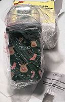 Popcorn maker wrapped in plastic beside damaged box and manual